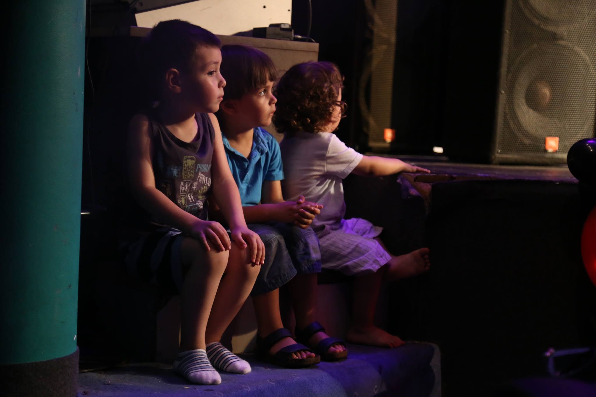 Children watching a magic performance closely